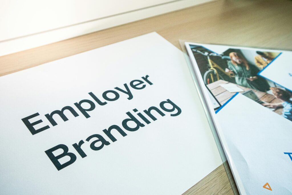 pexels-photo-15635235-15635235 Focus on employer branding with documents on a wooden desk, ideal for business concepts.