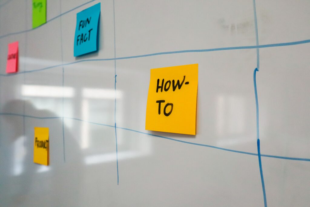 pexels-photo-15505432-15505432 Organized whiteboard with colorful sticky notes used for planning and brainstorming.