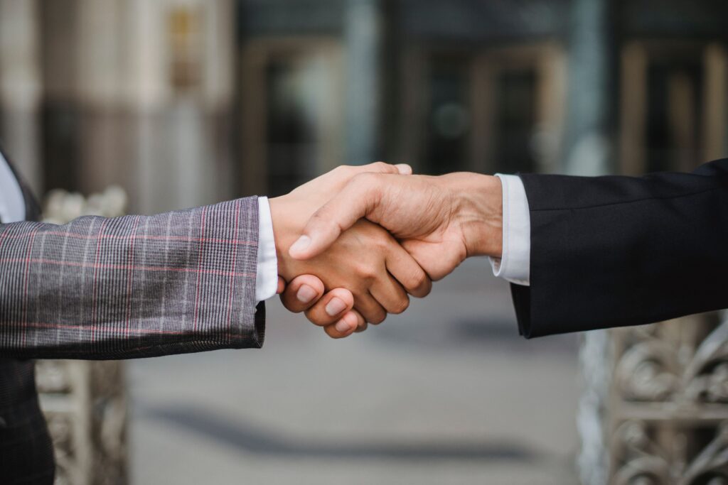 pexels-photo-4963437-4963437 A close-up of two businesspeople shaking hands, symbolizing cooperation and partnership.