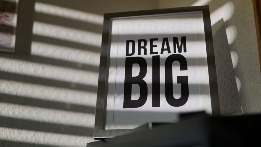 pexels-photo-945966-945966 Framed motivational 'Dream Big' text art creates an inspiring indoor ambiance.